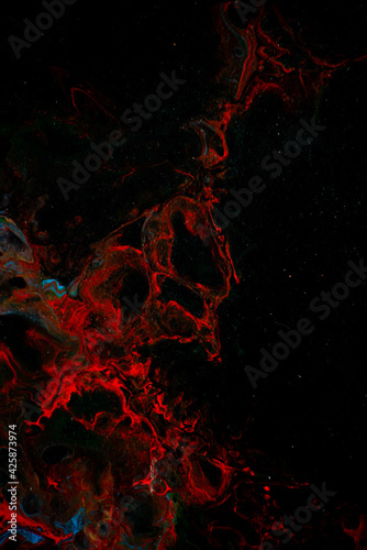 Texture in the style of fluid art. Abstract background with swirling paint effect. Liquid acrylic paint background. Black, blue and red colors.