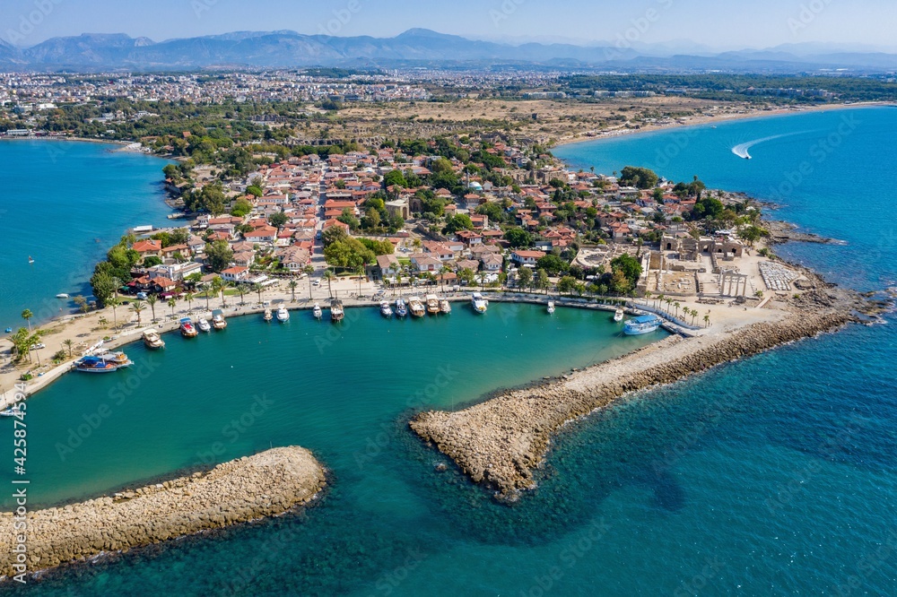 Aerial View Of Side Antique City . Side Old Town amphitheater. Side Harbor marina in Antalya Turkey drone view