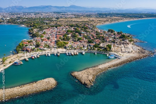 Fototapeta Naklejka Na Ścianę i Meble -  Aerial View Of Side Antique City . Side Old Town amphitheater. Side Harbor marina in Antalya Turkey drone view