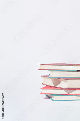 Srack of  old books on white background. Minimal concept. Good copy space.