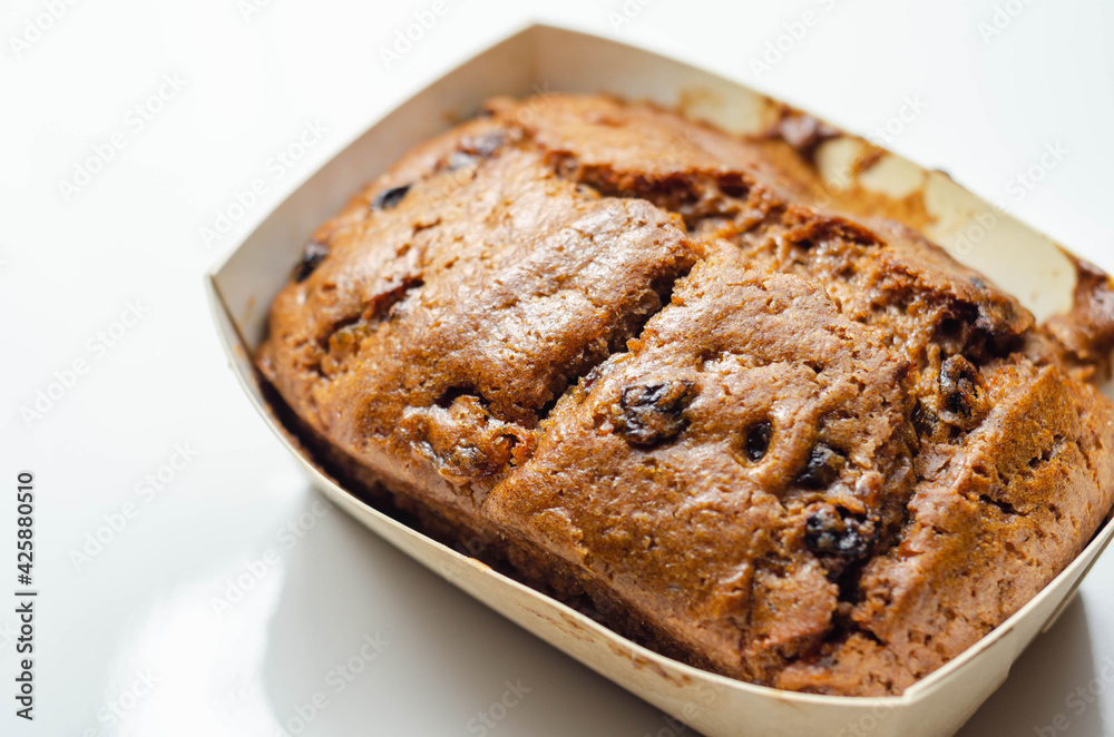 Freshly made spiced fruit loaf cake on the white background Freshly made spiced fruit loaf cake on the white background