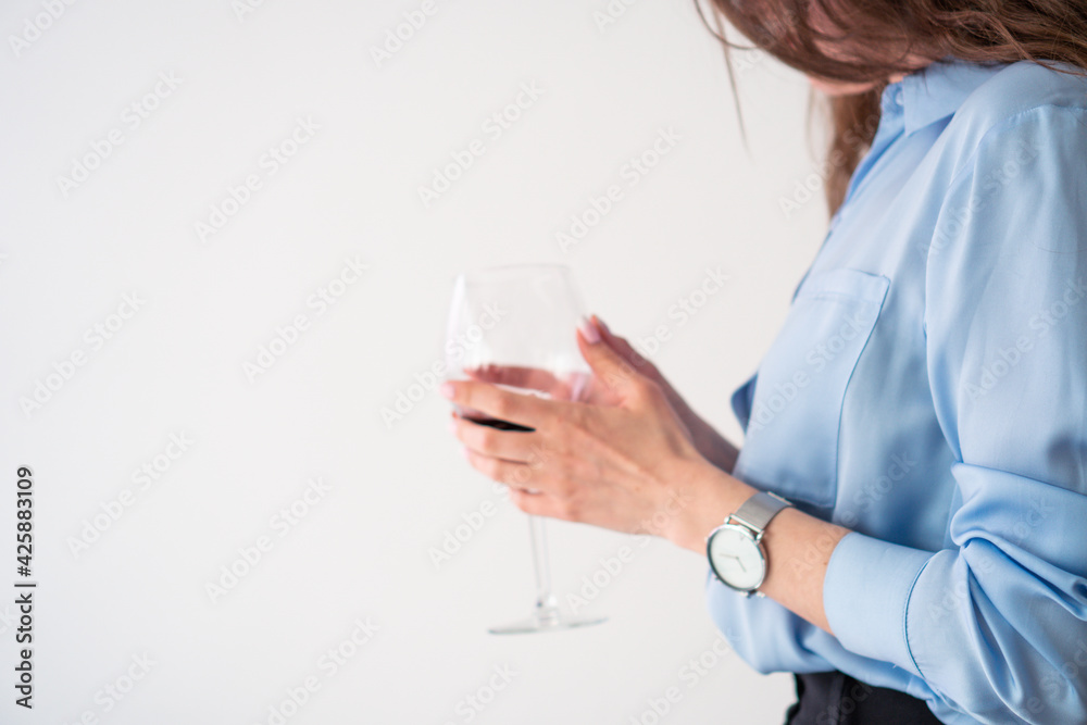 office girl in blue shirt and pearl necklace with glass of wine office girl in blue shirt and pearl necklace with glass of wine