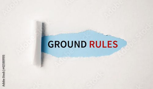 The text GROUND RULEs appearing behind torn white paper