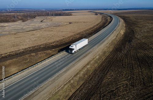 Aerial Top View of White Truck with Cargo Semi Trailer Moving on