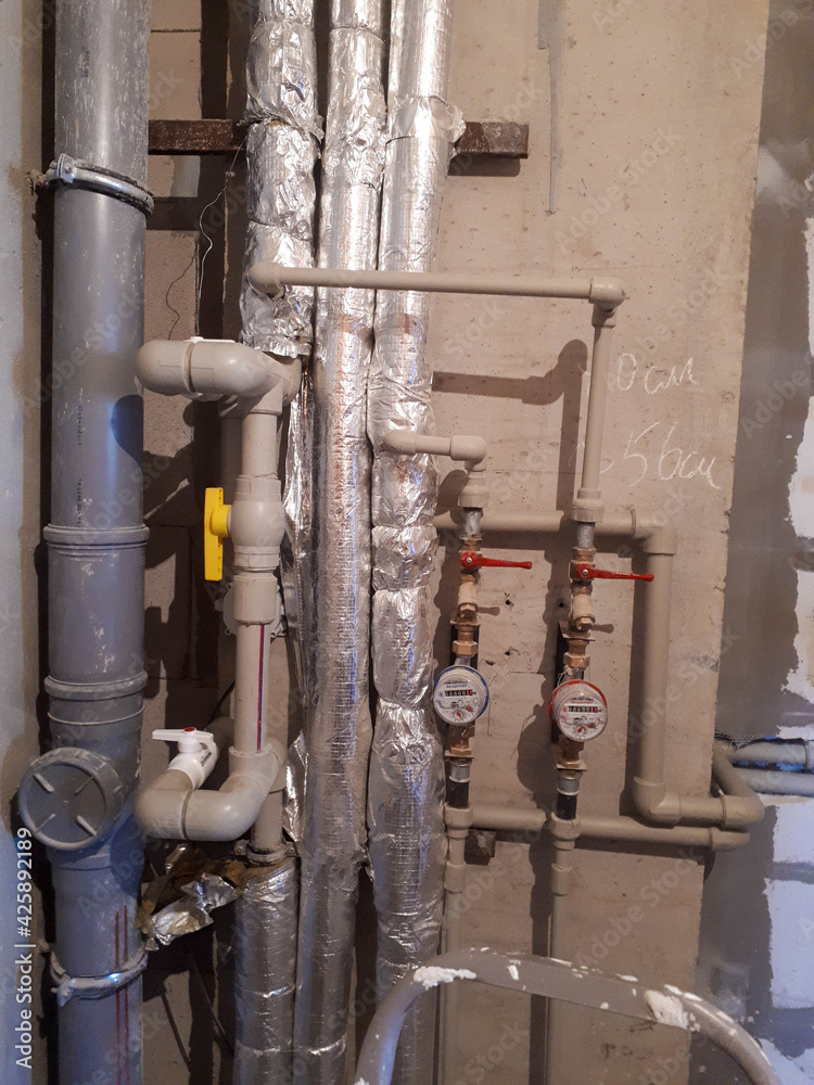 Layout of plastic plumbing pipes with water meters in a new studio apartment in a new building without repair Layout of plastic plumbing pipes with water meters in a new studio apartment in a new building without repair