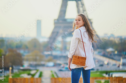 Young French woman in Paris near the Eiffel tower photo