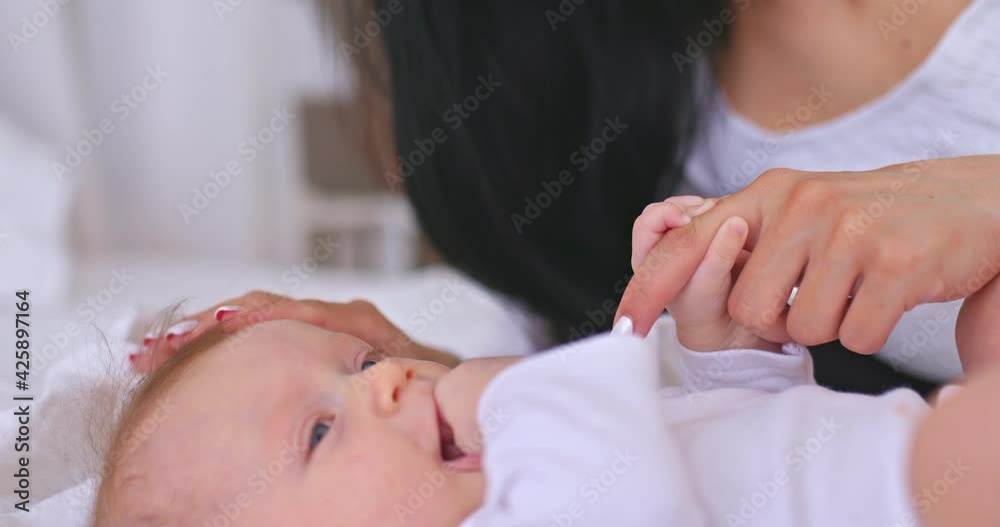 Portrait, newborn baby sucks a finger in his mouth. Cute baby firmly holds his mother by the finger, family values. Happy childhood and motherhood. 4k, ProRes Portrait, newborn baby sucks a finger in his mouth. Cute baby firmly holds his mother by the finger, family values. Happy childhood and motherhood. 4k, ProRes