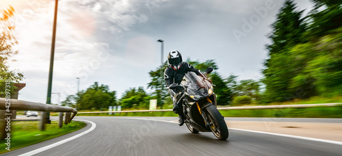 motorbike on the road riding. having fun riding the empty road on a motorcycle tour / journey