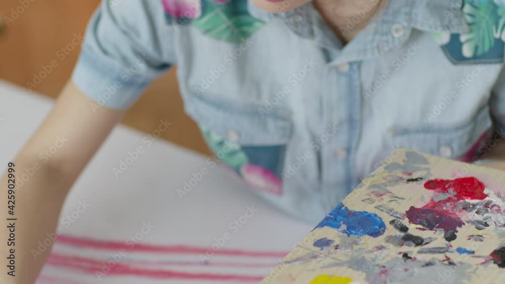 Female artist painting on canvas. Creative activity and inspiration concept. Talented people concept.