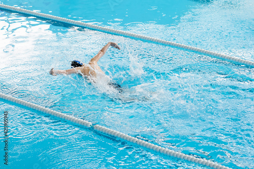 Man swimming in pool  blue water