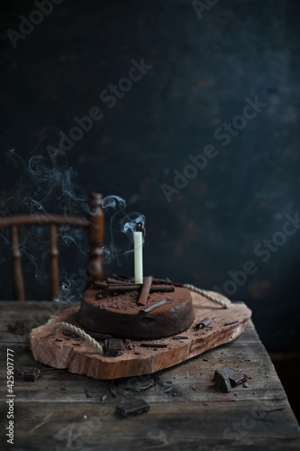 Chocolate cake with candles, Chocolate cake with mascarpone on rustic background.