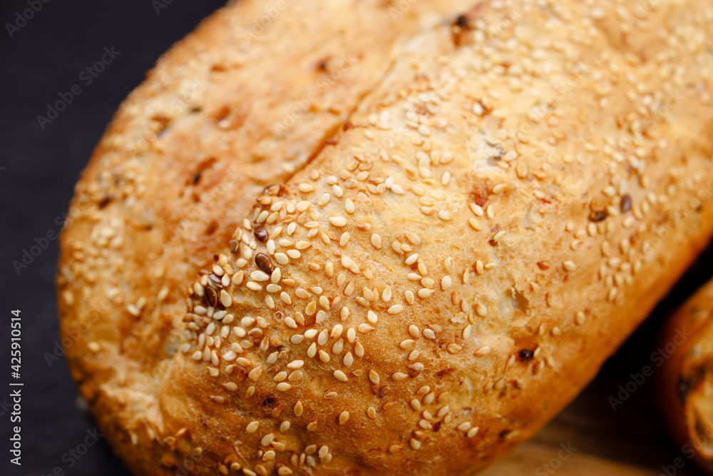 Freshly baked sliced wheat bread on cutting board