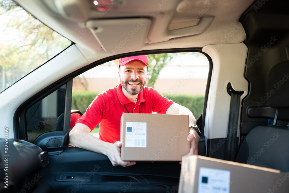 Portrait of an hispanic worker delivering a package Portrait of an hispanic worker delivering a package