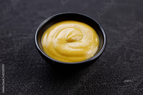 Mustard sauce dip in bowl, tasty food condiment