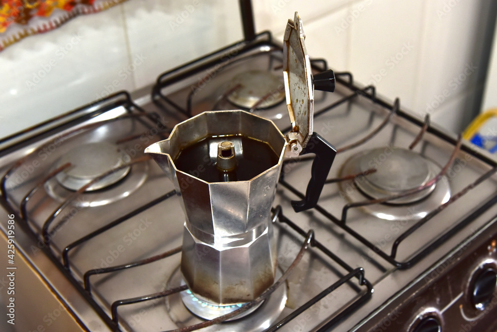 Italian coffee maker passing coffee on the stove. Italian coffee maker passing coffee on the stove.