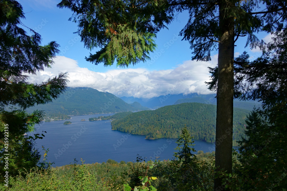 View up Burrard Inlet near Port Moody, BC, to  clouds massing over distant mountains