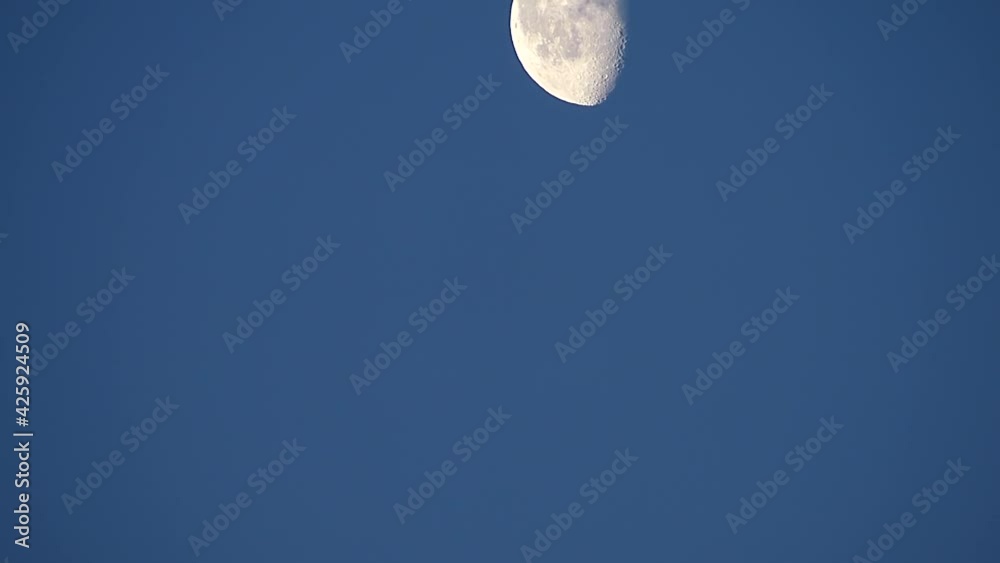 Moon on a background of blue sky copy space. Moon time lapse footage for design. Moon movement Moon on a background of blue sky copy space. Moon time lapse footage for design. Moon movement