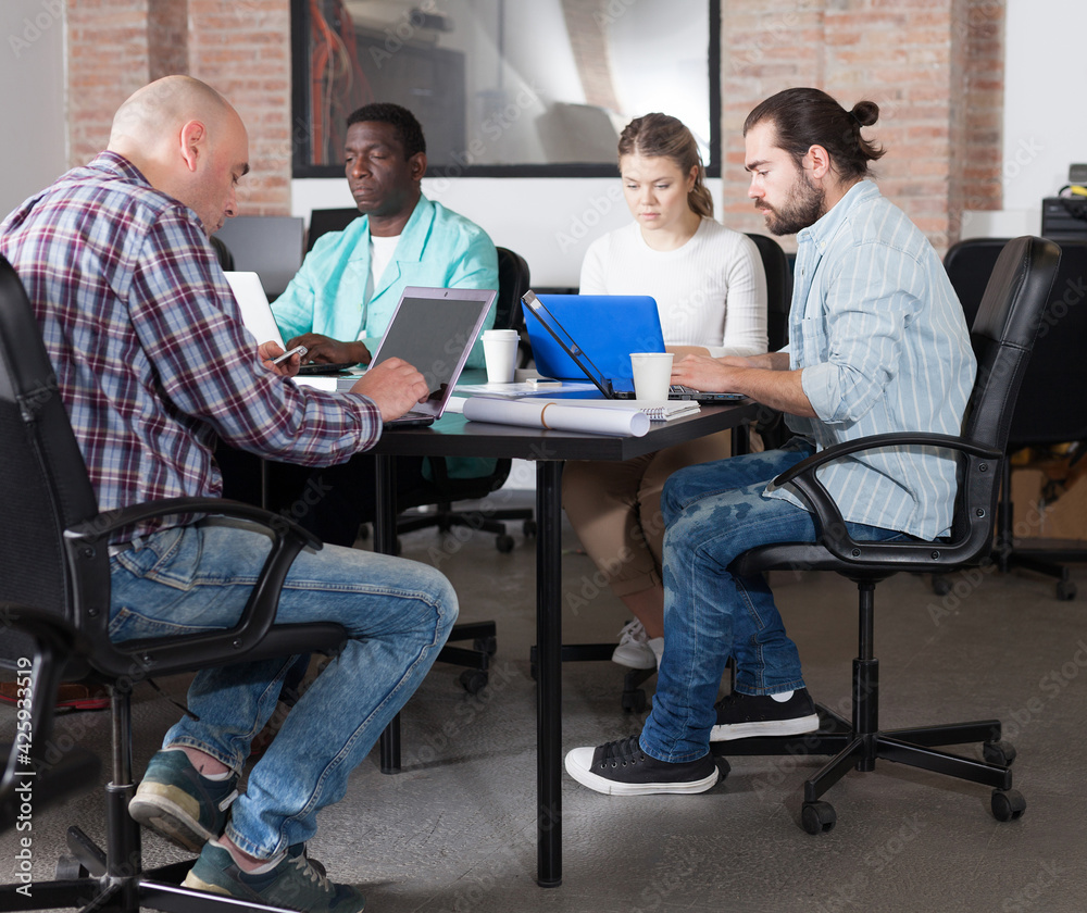 Fototapeta premium Group of multiracial people during daily work in modern co-working space
