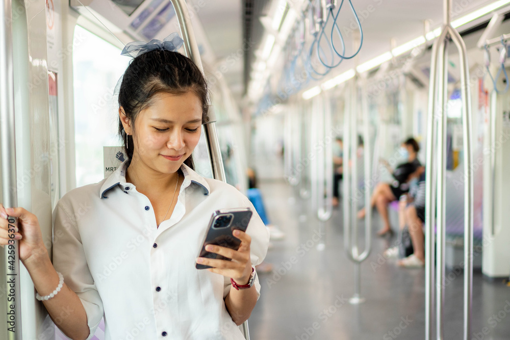 © thebigland45 - Young beautiful girl using smart phone inside empty subway or sky train car, leisure and daily life, Social media concept. © thebigland45 - Young beautiful girl using smart phone inside empty subway or sky train car, leisure and daily life, Social media concept.