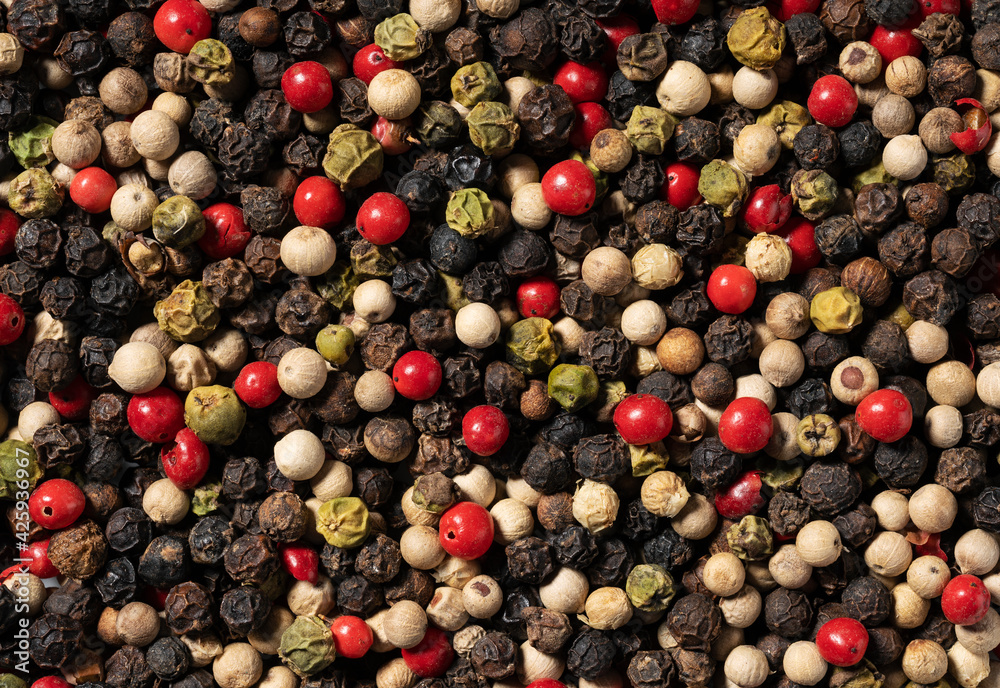 Background of mixed pepperscon. Peppercon in black, red, white and green. Background of mixed pepperscon. Peppercon in black, red, white and green.