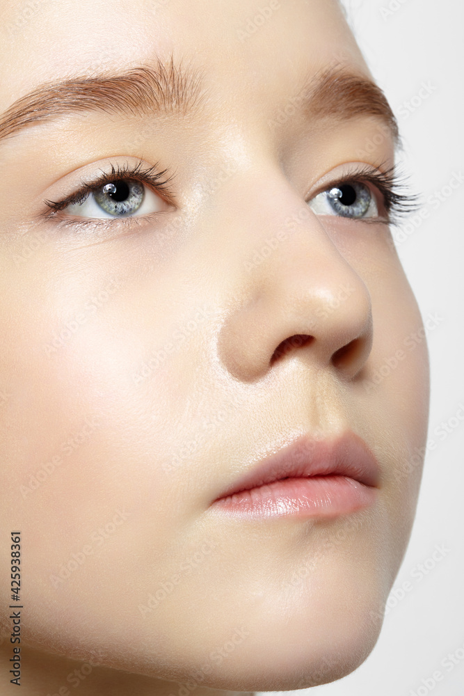 Closeup shot of human teenager girl face. Young female with natural face and eyes beauty makeup Closeup shot of human teenager girl face. Young female with natural face and eyes beauty makeup