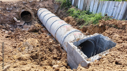 Wallpaper Mural Close up mainhole and old pipe. New concrete sewer with old pipes rotted in the trench to construct a ground-based drainage system and a fence with a copy area. Selective focus Torontodigital.ca
