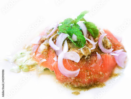 Salmon spicy salad in Thai style on white background