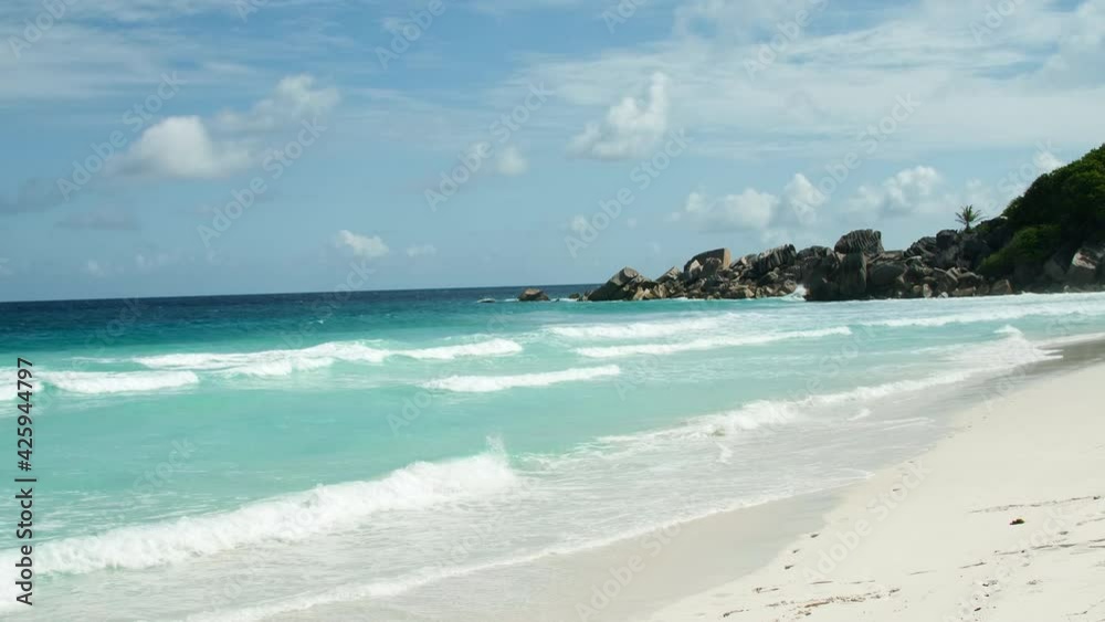 Gorgeous shot of the turquoise blue scenic La Digue beach. Tourist running landscape of tropical island vacation paradise Seychelles, Indian Ocean on a sunny summer day granite rock formations Gorgeous shot of the turquoise blue scenic La Digue beach. Tourist running landscape of tropical island vacation paradise Seychelles, Indian Ocean on a sunny summer day granite rock formations