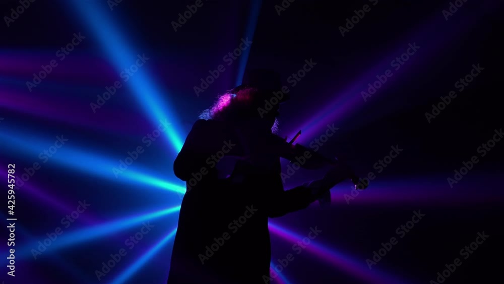 Bottom view virtuoso performance by a violinist in a dark studio with blinking blue violet beams of light. Violin playing, recital, live performance, rock and classical. Close up.