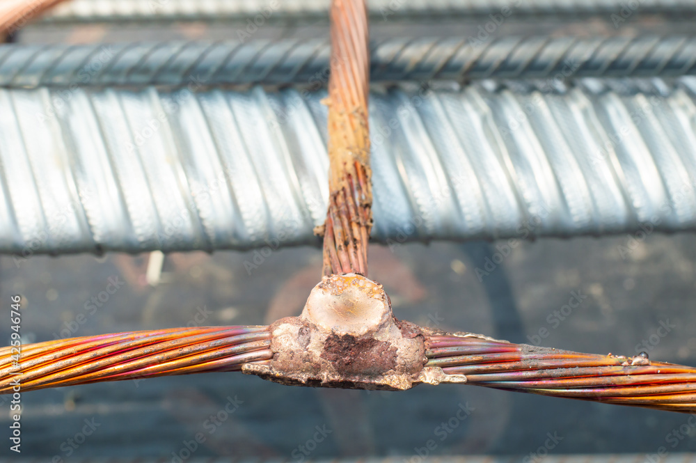 Welding copper ground wire on ground rod.Welding copper ground wire