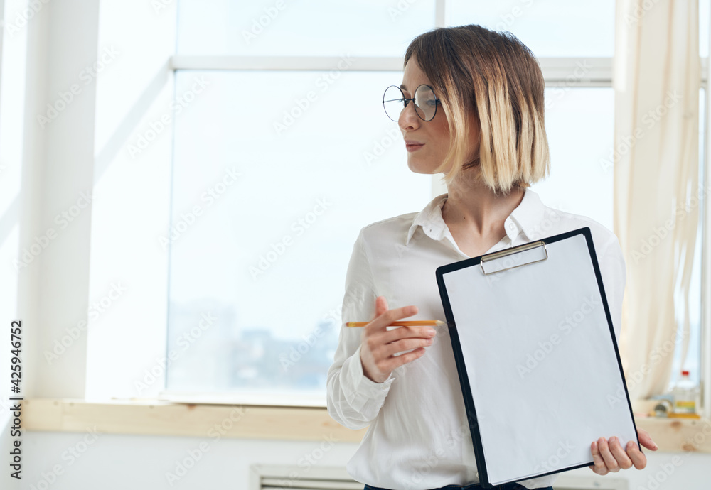 Woman rooming near window interior Folder with documents white sheet of paper Woman rooming near window interior Folder with documents white sheet of paper