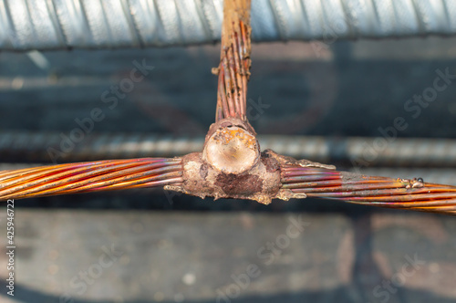 Obraz na plátně Welding copper ground wire on ground rod