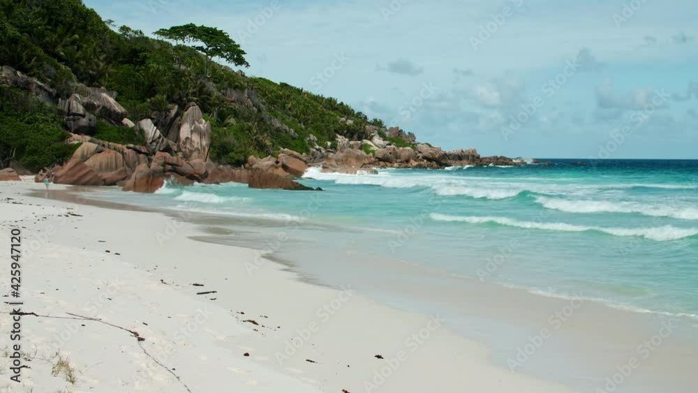 Amazing shot of the turquoise blue ocean on scenic La Digue island beach. White sand tropical island vacation honeymoon paradise Seychelles, Indian Ocean on a sunny summer day granite rock formations Amazing shot of the turquoise blue ocean on scenic La Digue island beach. White sand tropical island vacation honeymoon paradise Seychelles, Indian Ocean on a sunny summer day granite rock formations