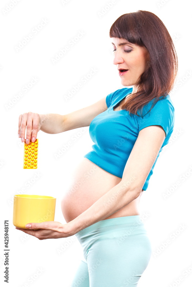 Woman in pregnant throwing medical pills or capsules, reduction of using tablets in pregnancy Woman in pregnant throwing medical pills or capsules, reduction of using tablets in pregnancy