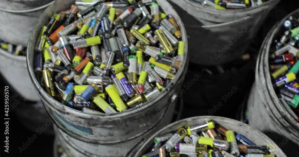 Lots of used batteries sorted into buckets. Top view. Recycling. Environmental protection concept.