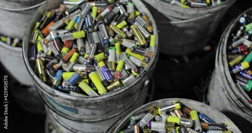 Lots of used batteries sorted into buckets. Top view. Recycling. Environmental protection concept.