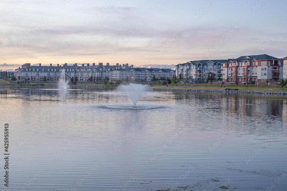 Residential complex apartments with lake and fountains in foreground