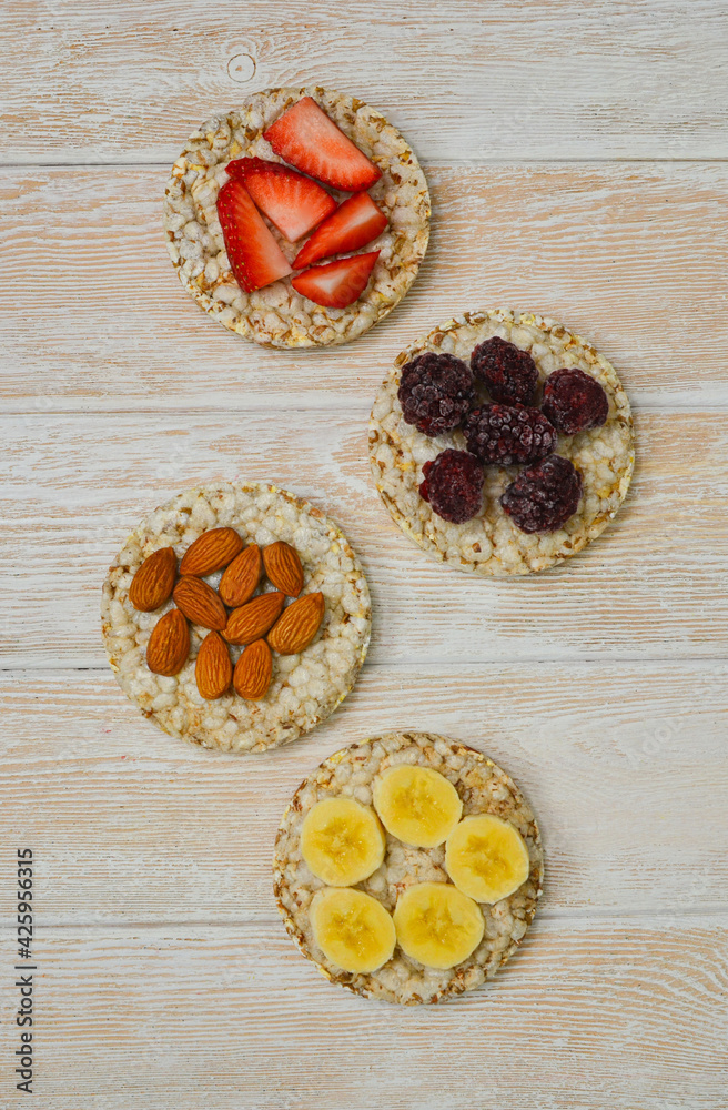 Fototapeta premium cereal breakfast crisp breads with strawberries, almonds nuts, banana fruit and blackberries