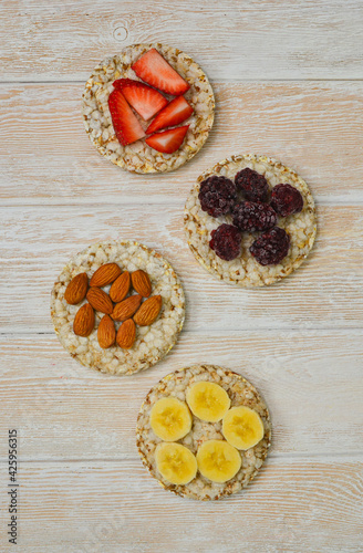 cereal breakfast crisp breads with strawberries, almonds nuts, banana fruit and blackberries