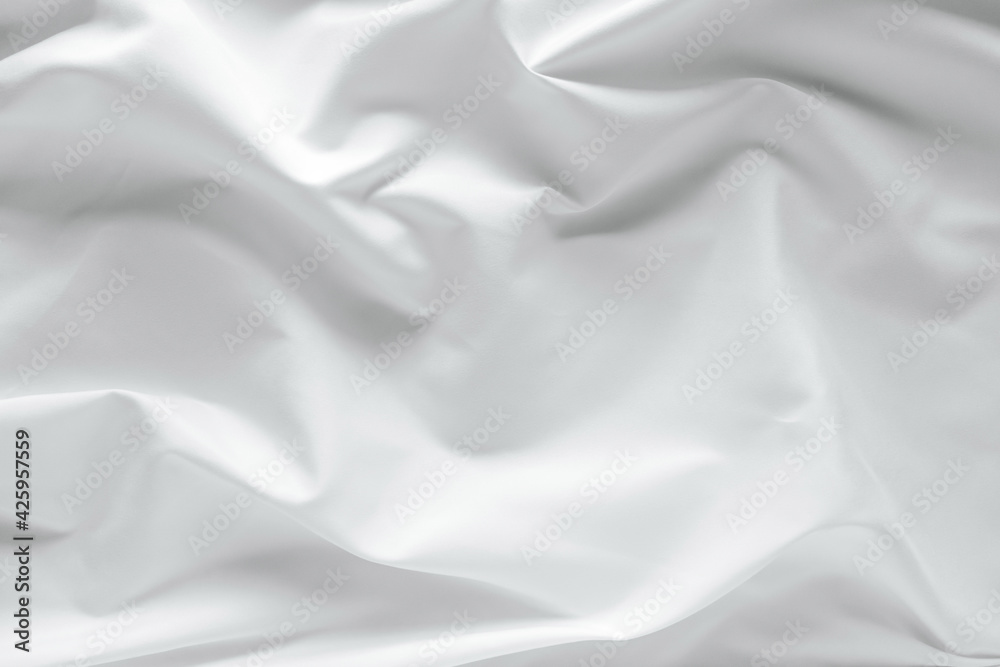 Abstract white fabric texture background. Cloth soft wave. Creases of satin. silk and cotton.	