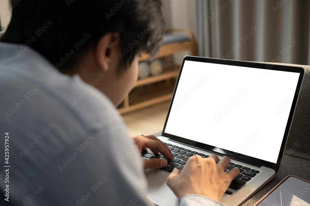 Close up view asian man lying on sofa and surfing internet with computer laptop. Close up view asian man lying on sofa and surfing internet with computer laptop.