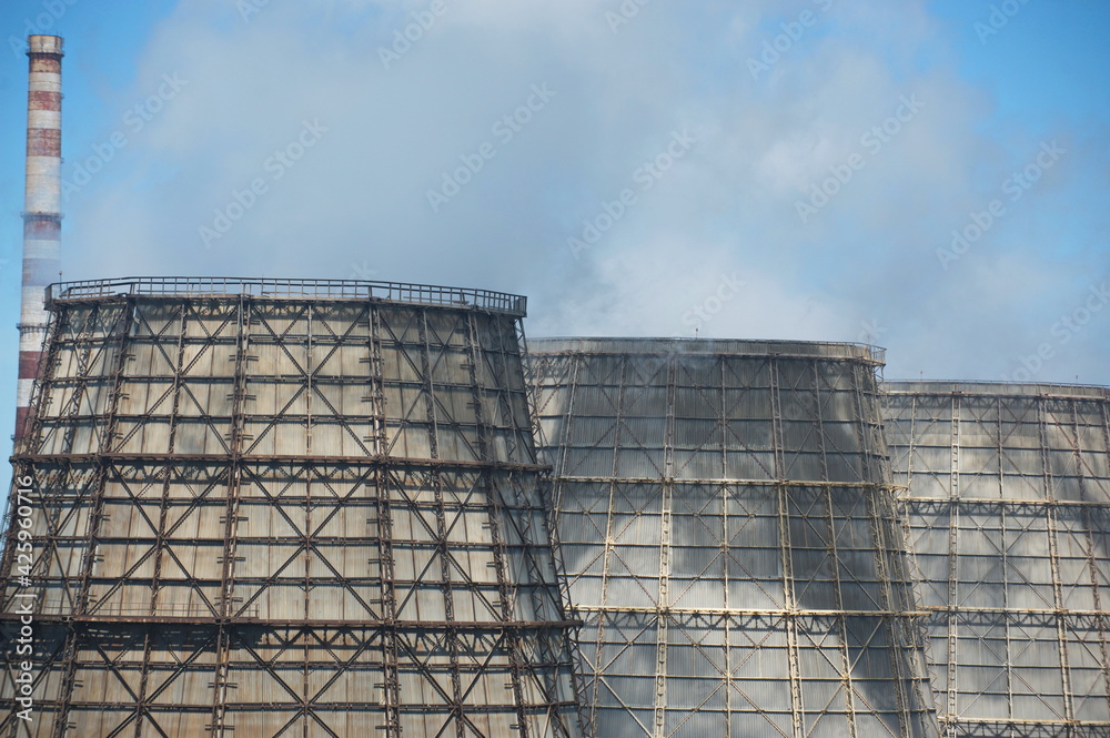 Pavlodar, Kazakhstan - 05.29.2015 : Cooling towers and pipes of various compartments of a large thermal power plant