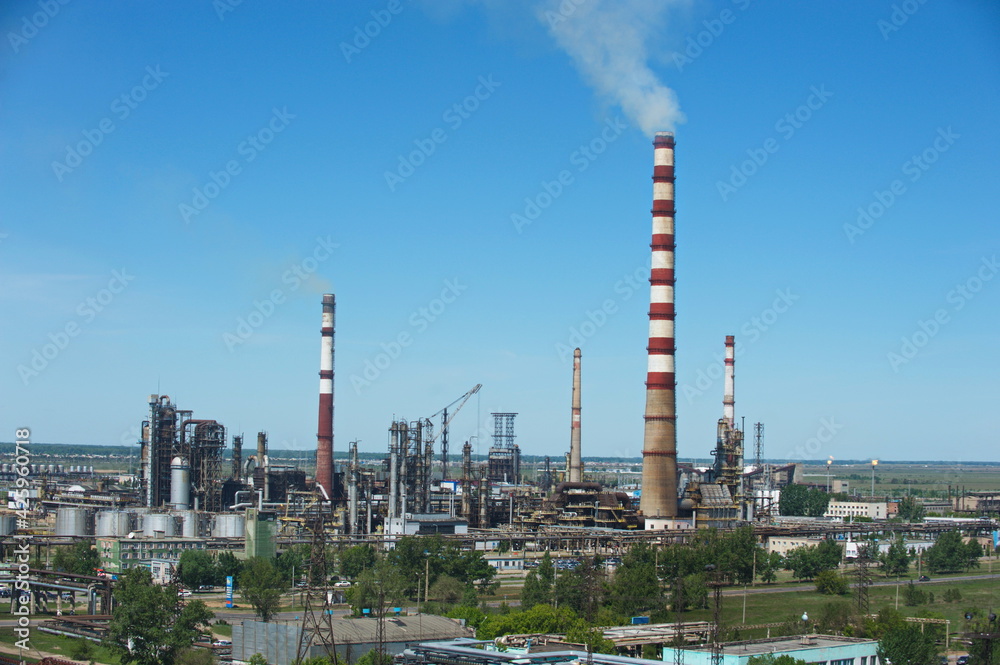 Pavlodar, Kazakhstan - 05.29.2015 : The territory of a thermal power plant with various industrial compartments and pipes. Pavlodar, Kazakhstan - 05.29.2015 : The territory of a thermal power plant with various industrial compartments and pipes.