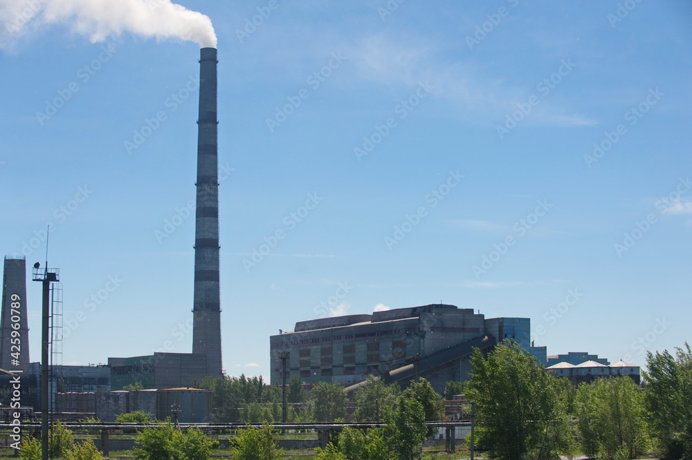 Pavlodar, Kazakhstan - 05.29.2015 : The territory of a thermal power plant with various industrial compartments and pipes.