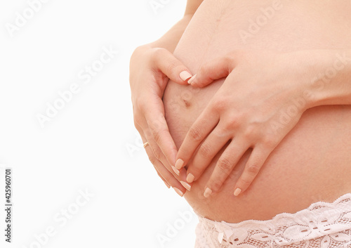 belly of a pregnant woman on a white background