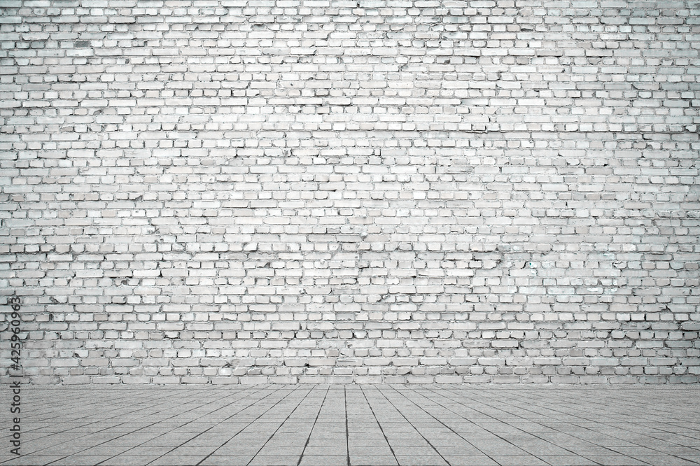 Fototapeta premium Empty room with bricks wall and tiled floor.