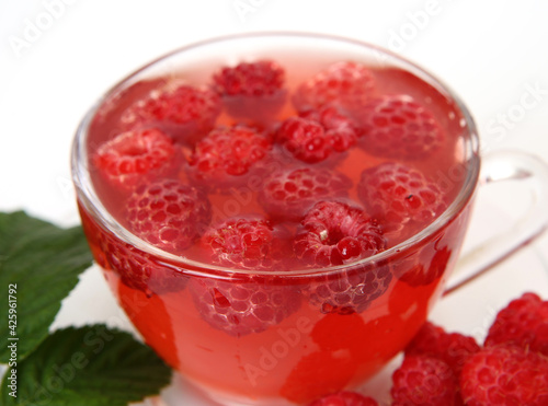 tea with raspberries on a white background