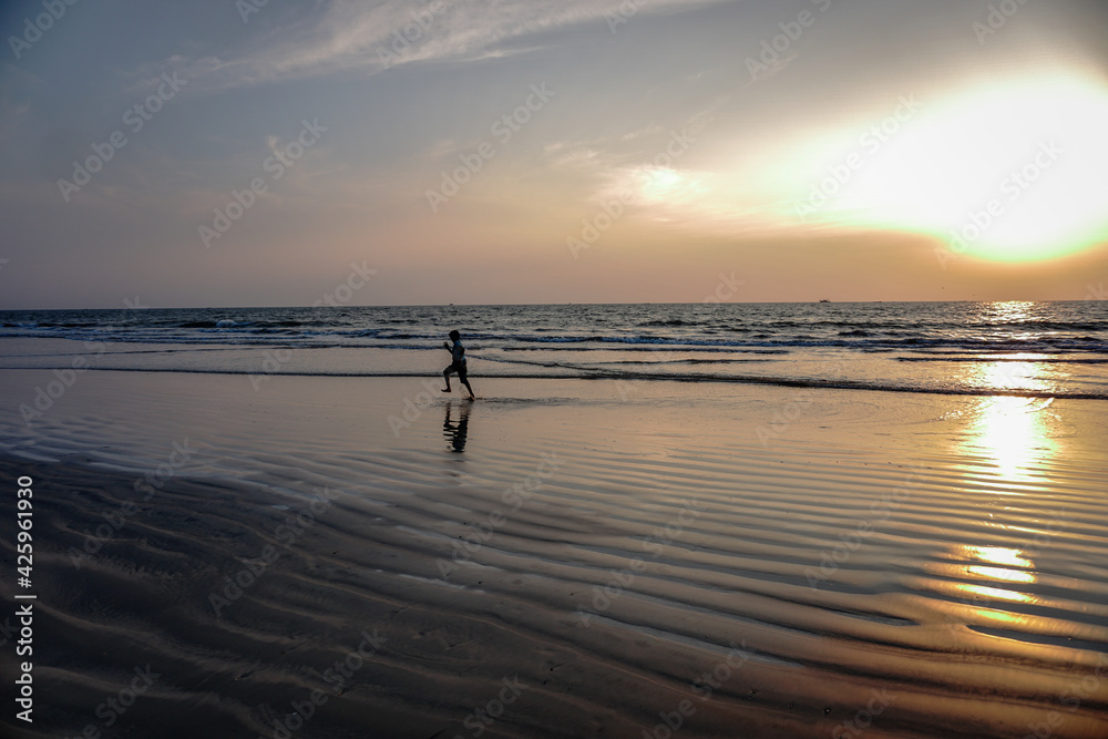 Toddler running at sunset on the beach