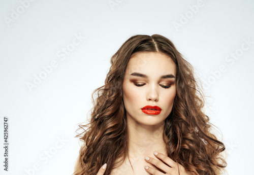 Woman portrait bright makeup curly hair nude shoulders model