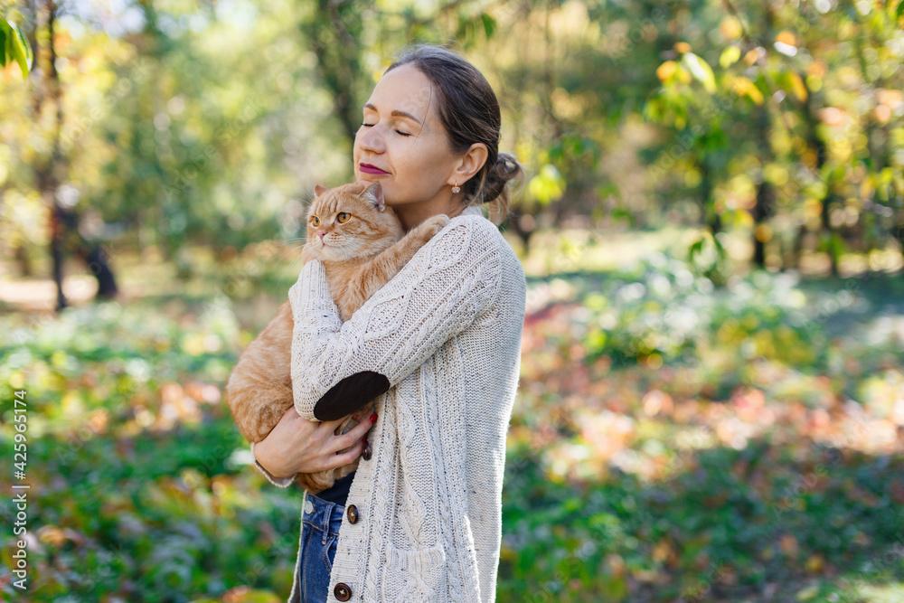 portrait a woman stroking big red fluffy cat on nature.
friendship people and animal. smiling woman and her lovely funny pet on walk outdoors. healthy young cat with owner. Pets and lifestyle concept portrait a woman stroking big red fluffy cat on nature.
friendship people and animal. smiling woman and her lovely funny pet on walk outdoors. healthy young cat with owner. Pets and lifestyle concept